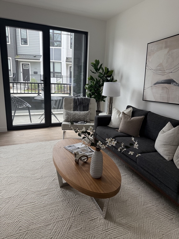 199 Gardner Street, Unit 403 Boston, MA 02132 - Photo 2 of 3 a living room with furniture and a large window