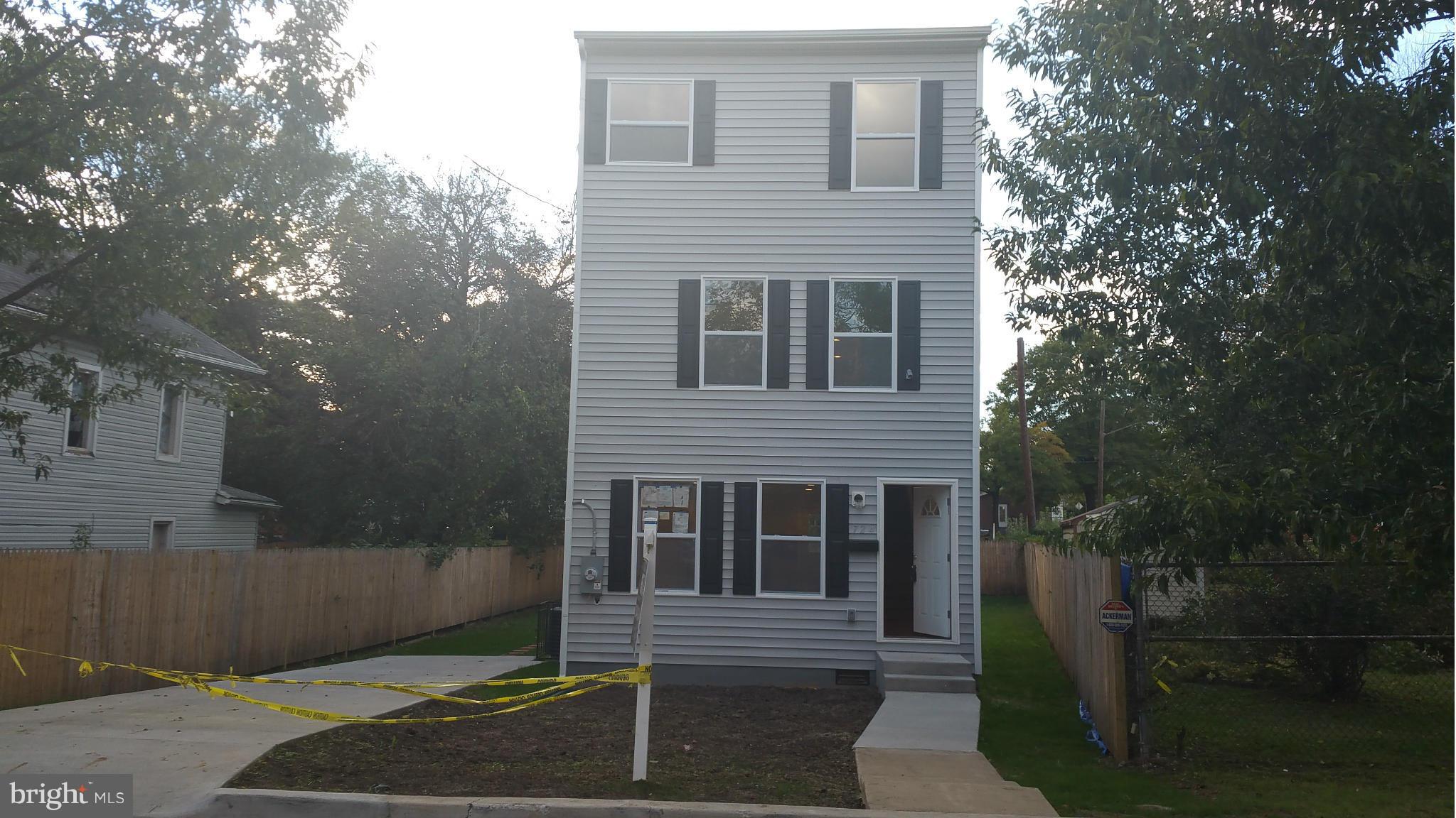 724 49th Place Northeast Washington, DC 20019 - Photo 1 of 30 a front view of a house with a yard