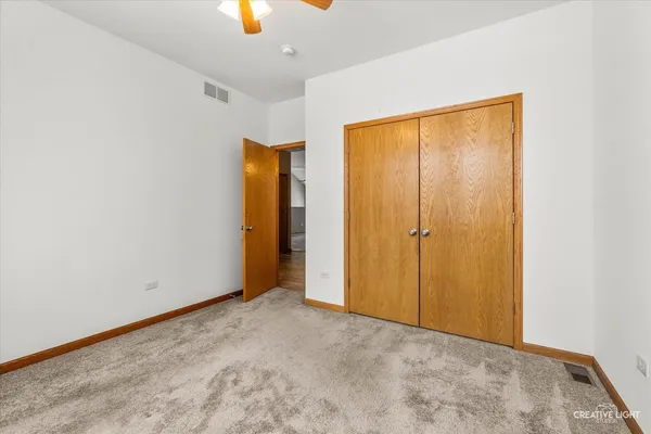 an empty room with windows and closet