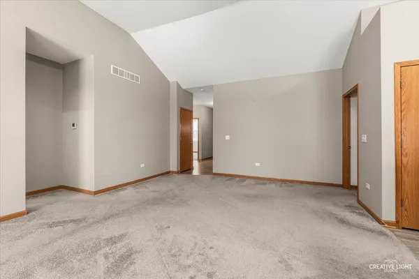 an empty room with windows and closet