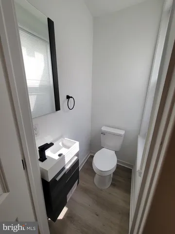 a bathroom with a toilet sink and mirror