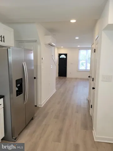 a view of a refrigerator in kitchen and wooden floor