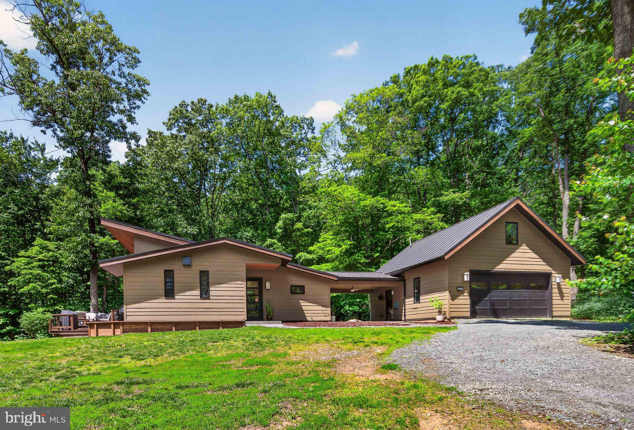 13311 Wilt Store Road Leesburg, VA 20176 - Photo 1 of 64 Modern home nestled in lush greenery.