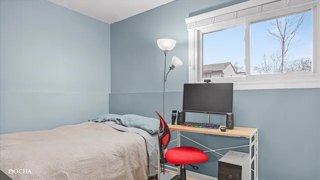 a bedroom with a bed and a desk