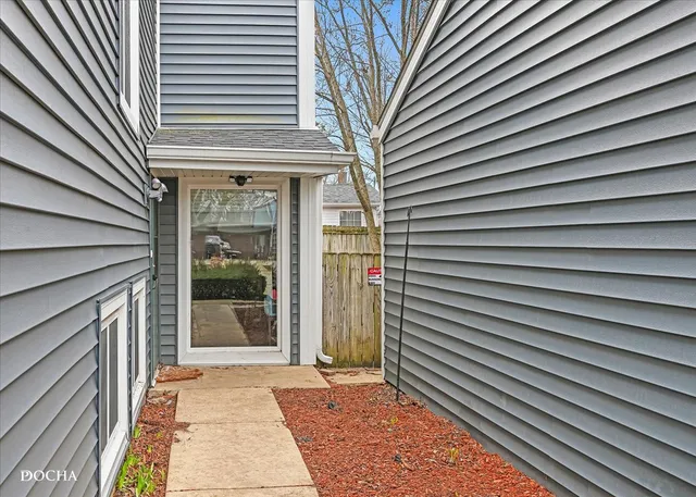 a view of a house with a door and wooden floor