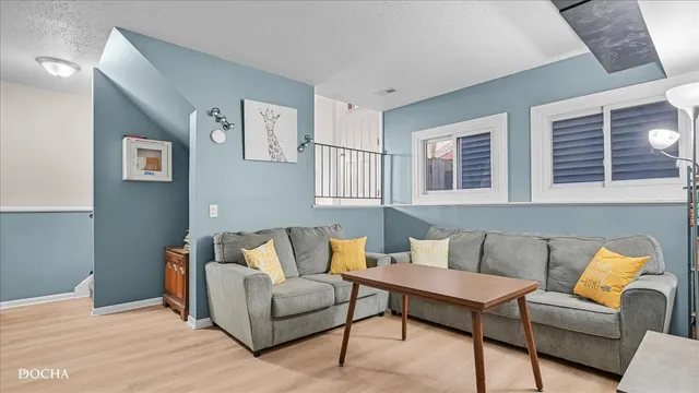 a living room with furniture and a potted plant