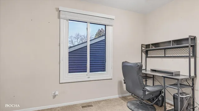 a view of a workspace room with wooden floor and chair