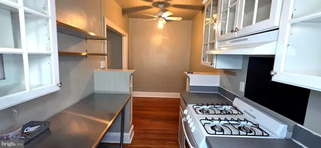 a kitchen with stainless steel appliances a stove a sink and a refrigerator
