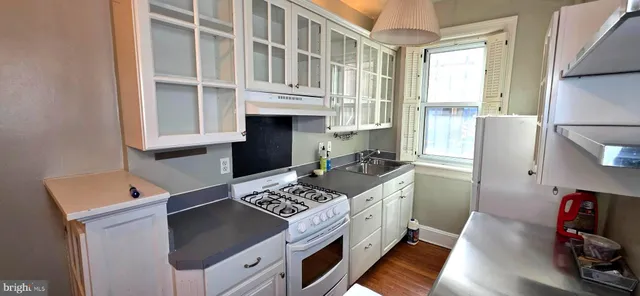 a kitchen with a refrigerator and a stove