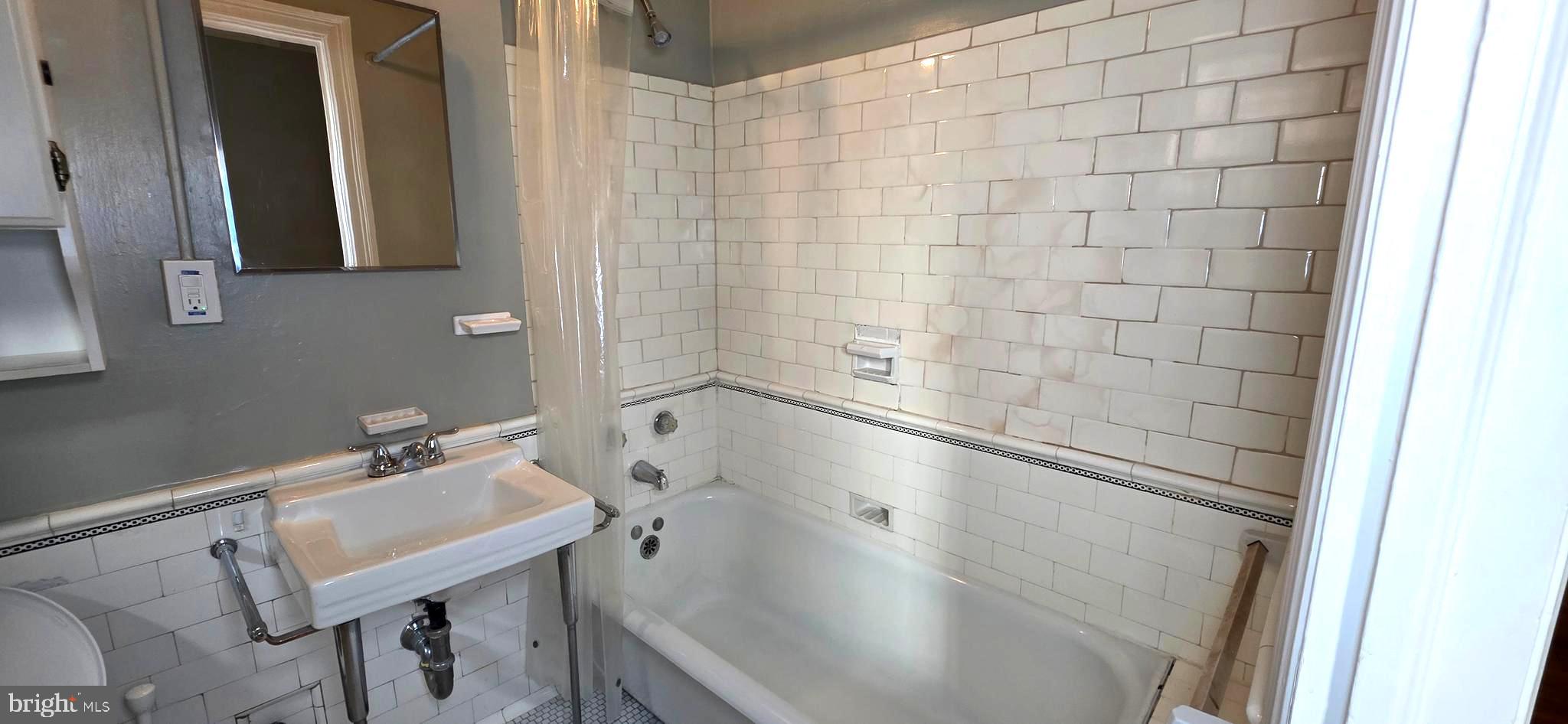1954 Columbia Road Northwest, Unit 104 Washington, DC 20009 - Photo 17 of 18 a bathroom with a sink and a mirror
