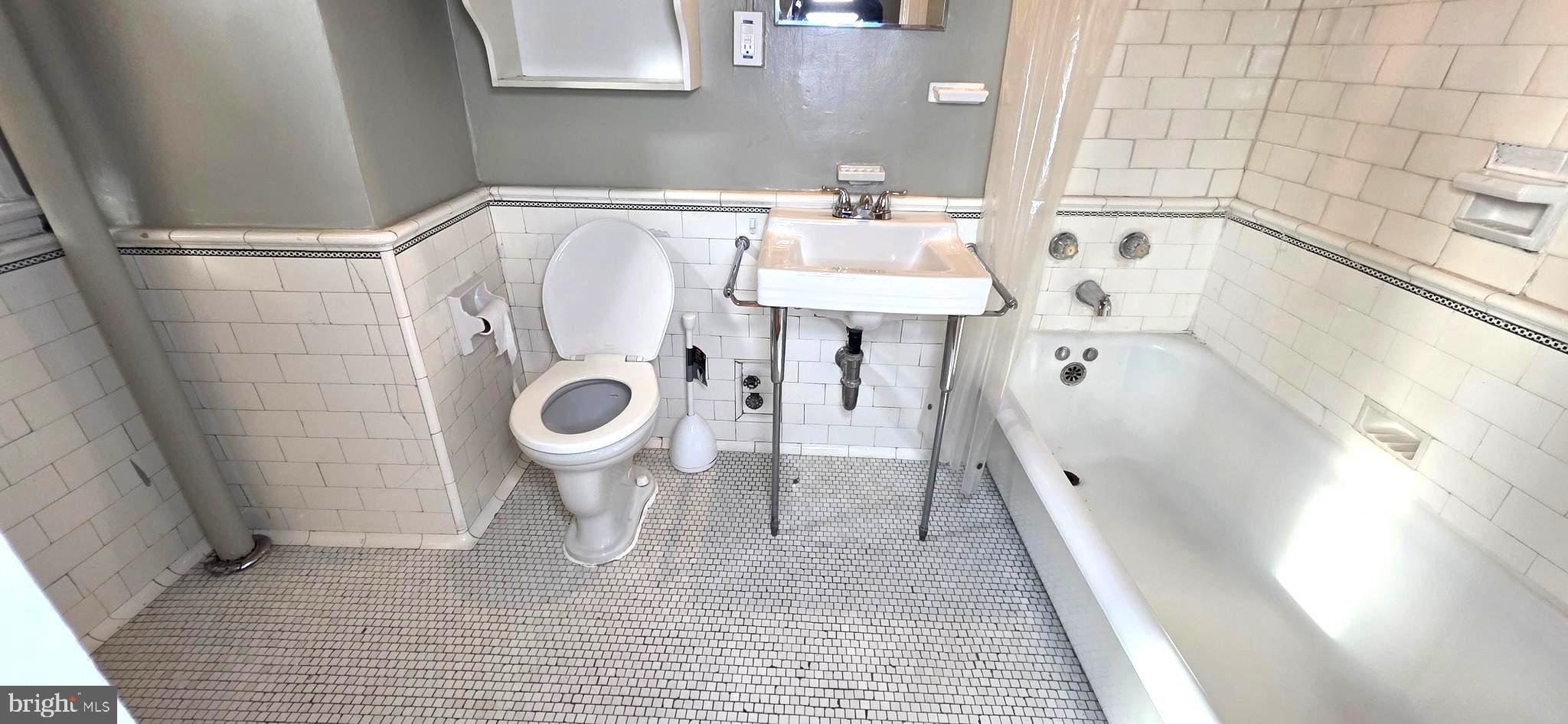 1954 Columbia Road Northwest, Unit 104 Washington, DC 20009 - Photo 18 of 18 a bathroom with a sink a toilet and shower