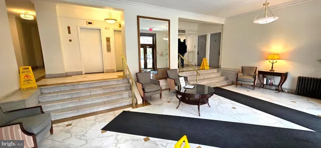 a view of living room with furniture and wooden floor