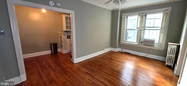 a view of a room with wooden floor and windows