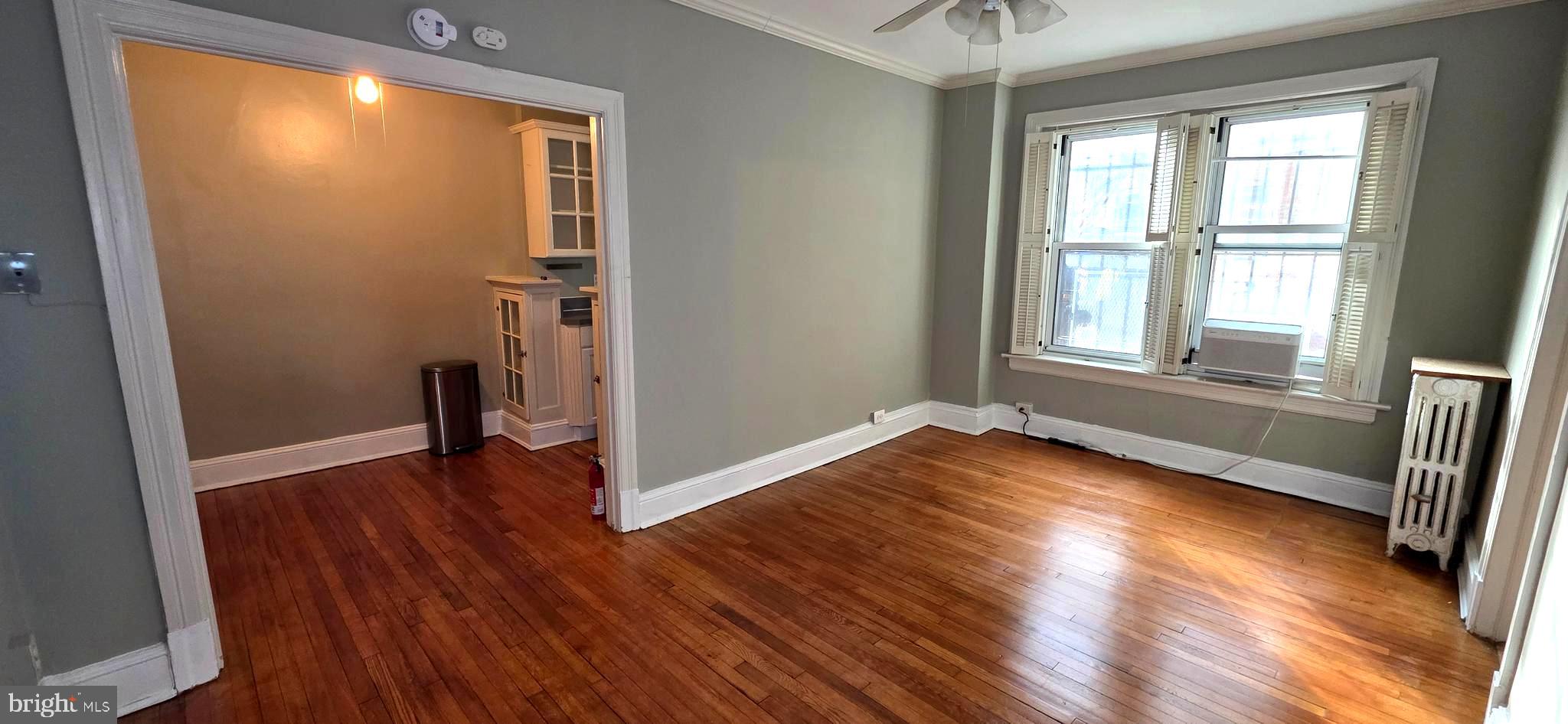 1954 Columbia Road Northwest, Unit 104 Washington, DC 20009 - Photo 6 of 18 an empty room with wooden floor and windows