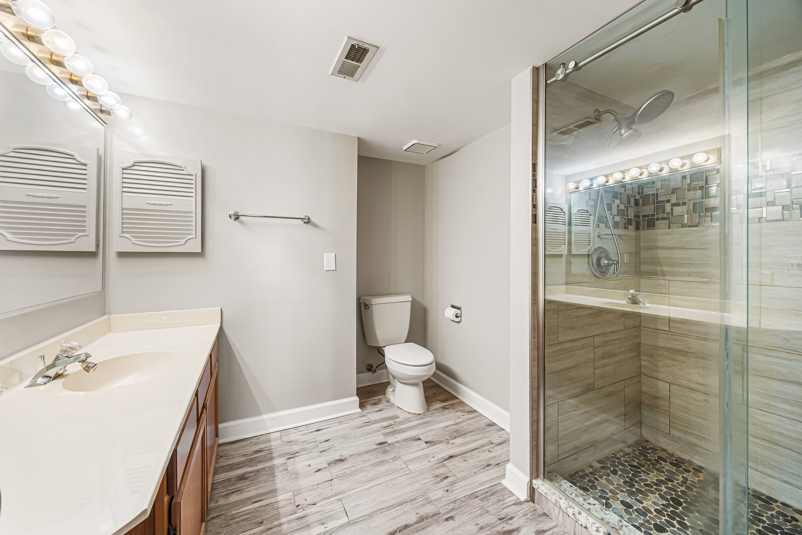 1226 Chalet Road, Unit 2102 Naperville, IL 60563 - Photo 16 of 28 a bathroom with a granite countertop sink a toilet and shower