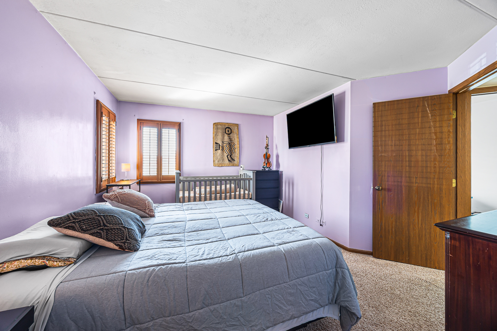 1226 Chalet Road, Unit 2102 Naperville, IL 60563 - Photo 20 of 28 a bedroom with a bed and a flat screen tv