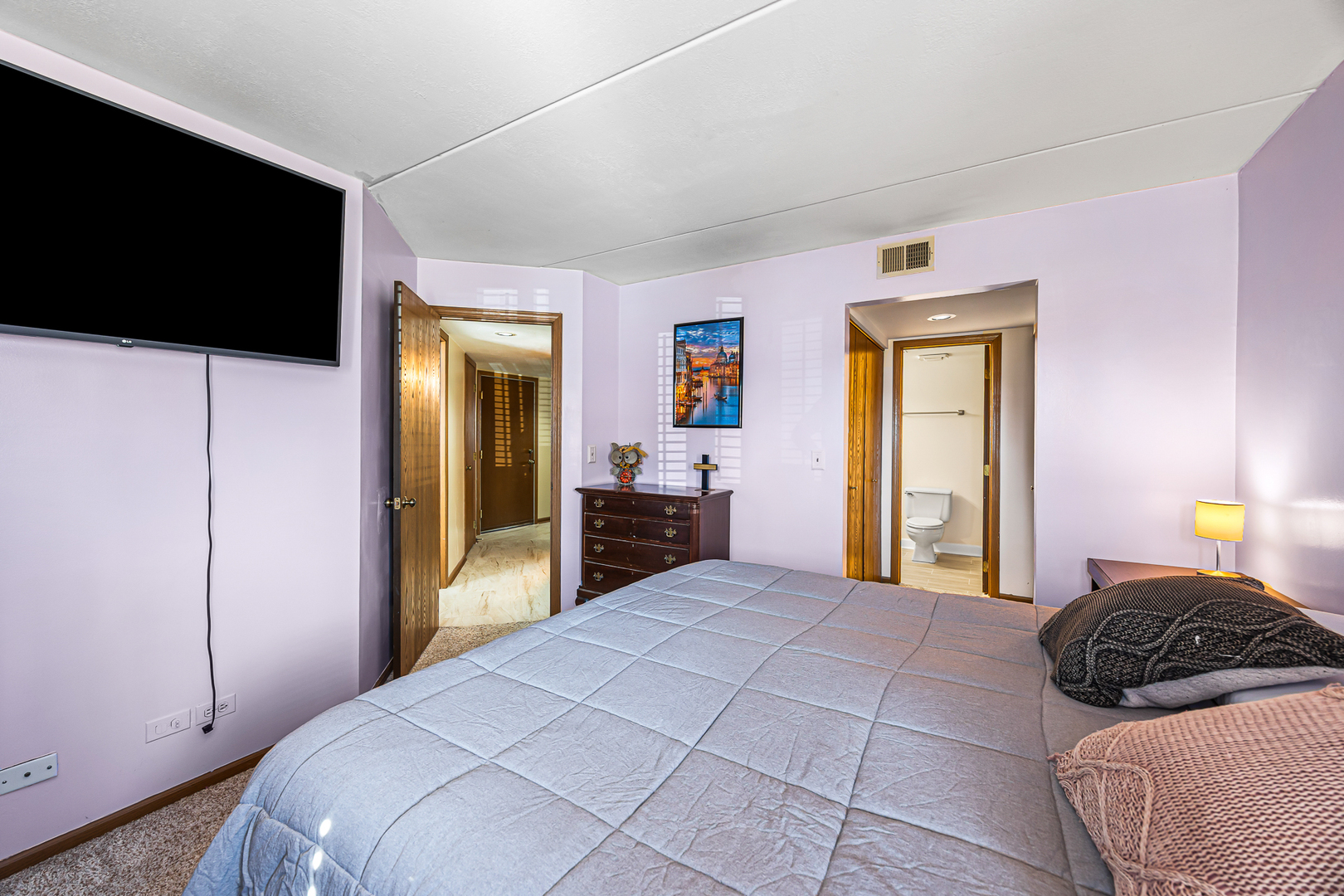 1226 Chalet Road, Unit 2102 Naperville, IL 60563 - Photo 21 of 28 a bedroom with a bed and a flat tv screen on dresser