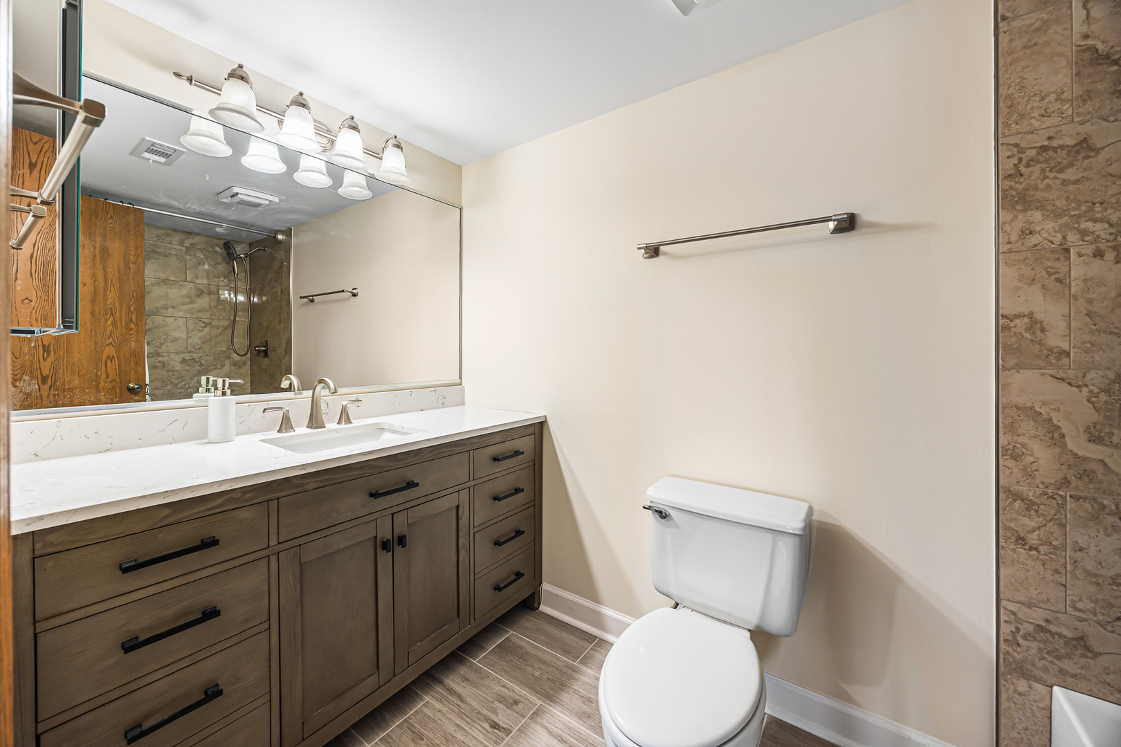 1226 Chalet Road, Unit 2102 Naperville, IL 60563 - Photo 22 of 28 a bathroom with a toilet a sink and mirror