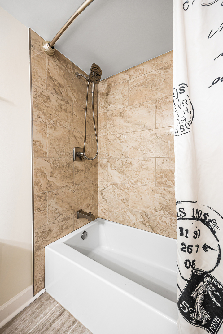 1226 Chalet Road, Unit 2102 Naperville, IL 60563 - Photo 23 of 28 a bathroom with a bathtub and shower