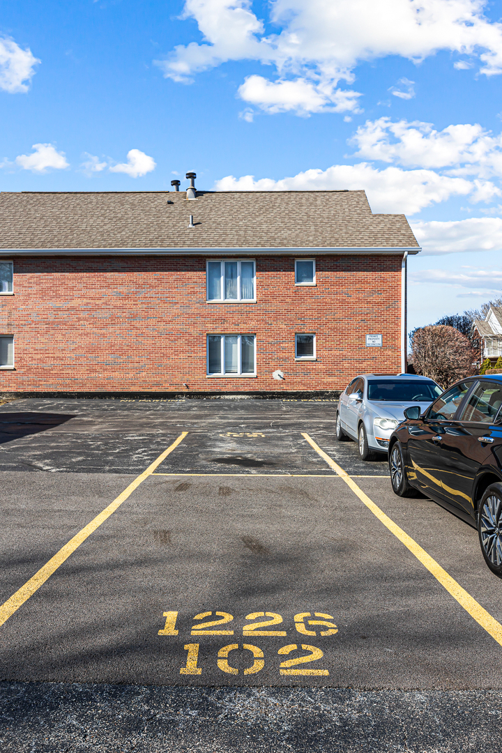 1226 Chalet Road, Unit 2102 Naperville, IL 60563 - Photo 26 of 28 a view of a street with cars parked