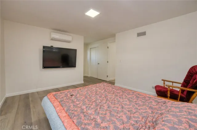 a bedroom with bed and flat screen tv