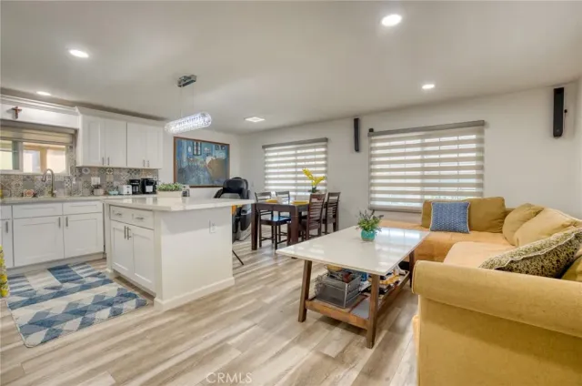 a living room with granite countertop furniture and kitchen view