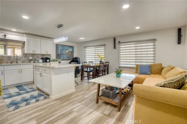 a living room with granite countertop furniture and kitchen view