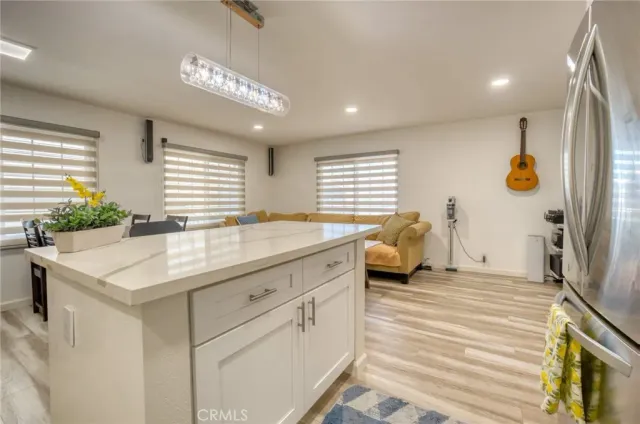 a en suite bathroom with a granite countertop sink and a large mirror