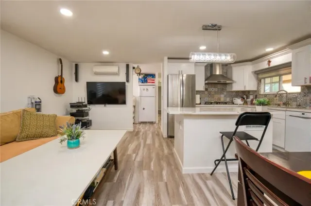 a kitchen with stainless steel appliances kitchen island granite countertop a sink and cabinets