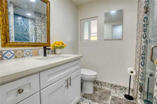 a bathroom with a sink toilet and mirror