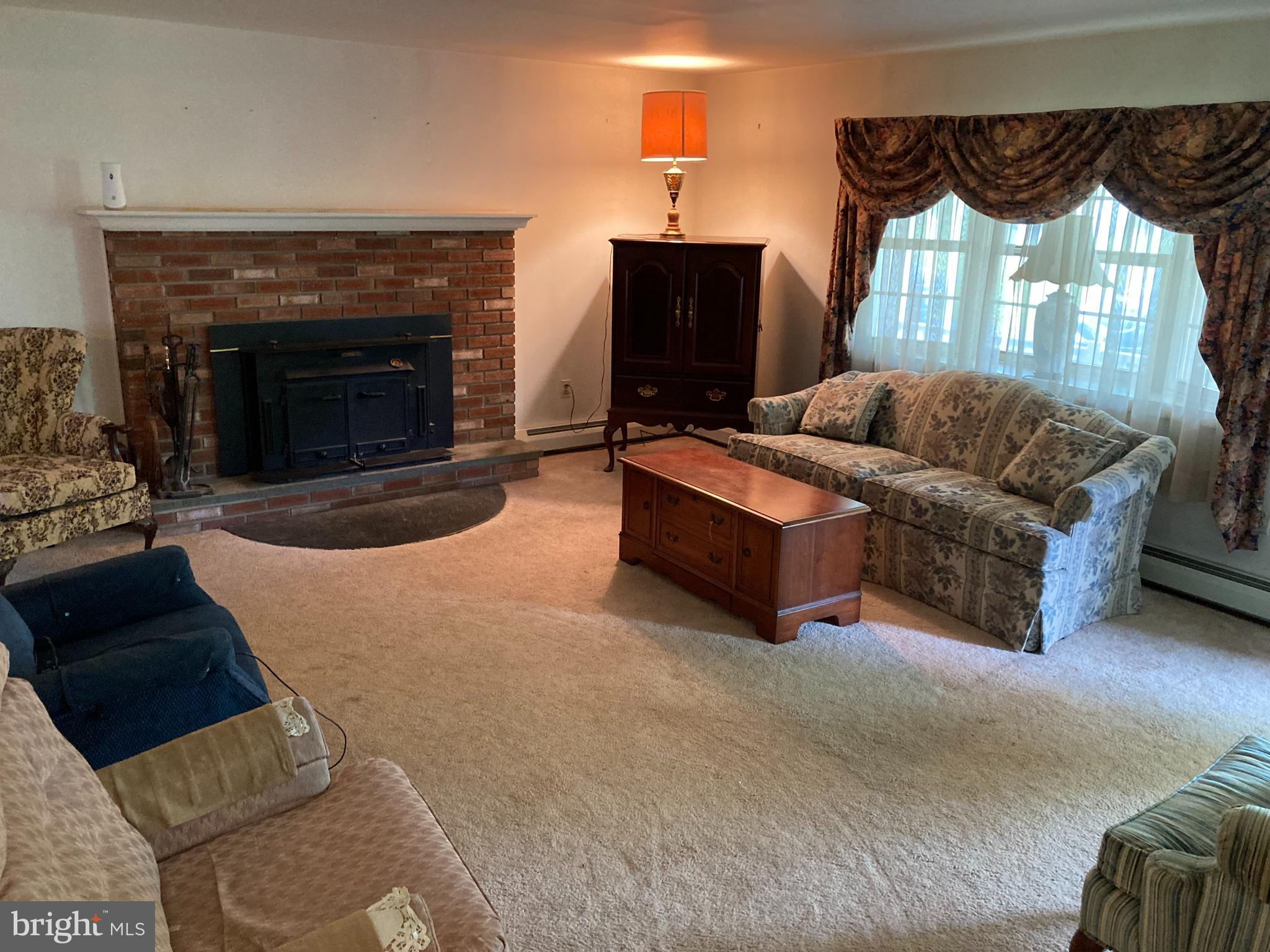 580 Jacksonville Road Warminster, PA 18974 - Photo 4 of 20 a living room with furniture and a fireplace