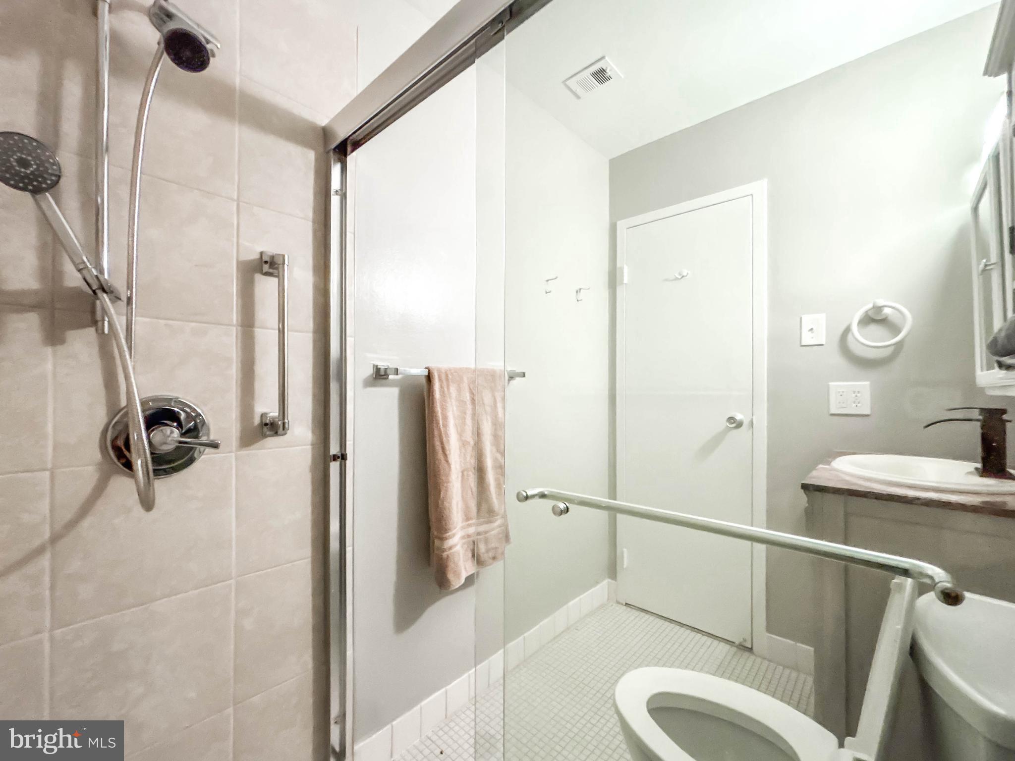130 Slade Avenue, Unit 414 Baltimore, MD 21208 - Photo 34 of 48 a bathroom with a sink toilet and shower
