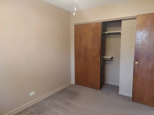 an empty room with closet area