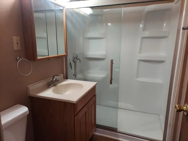 a bathroom with a sink toilet and shower