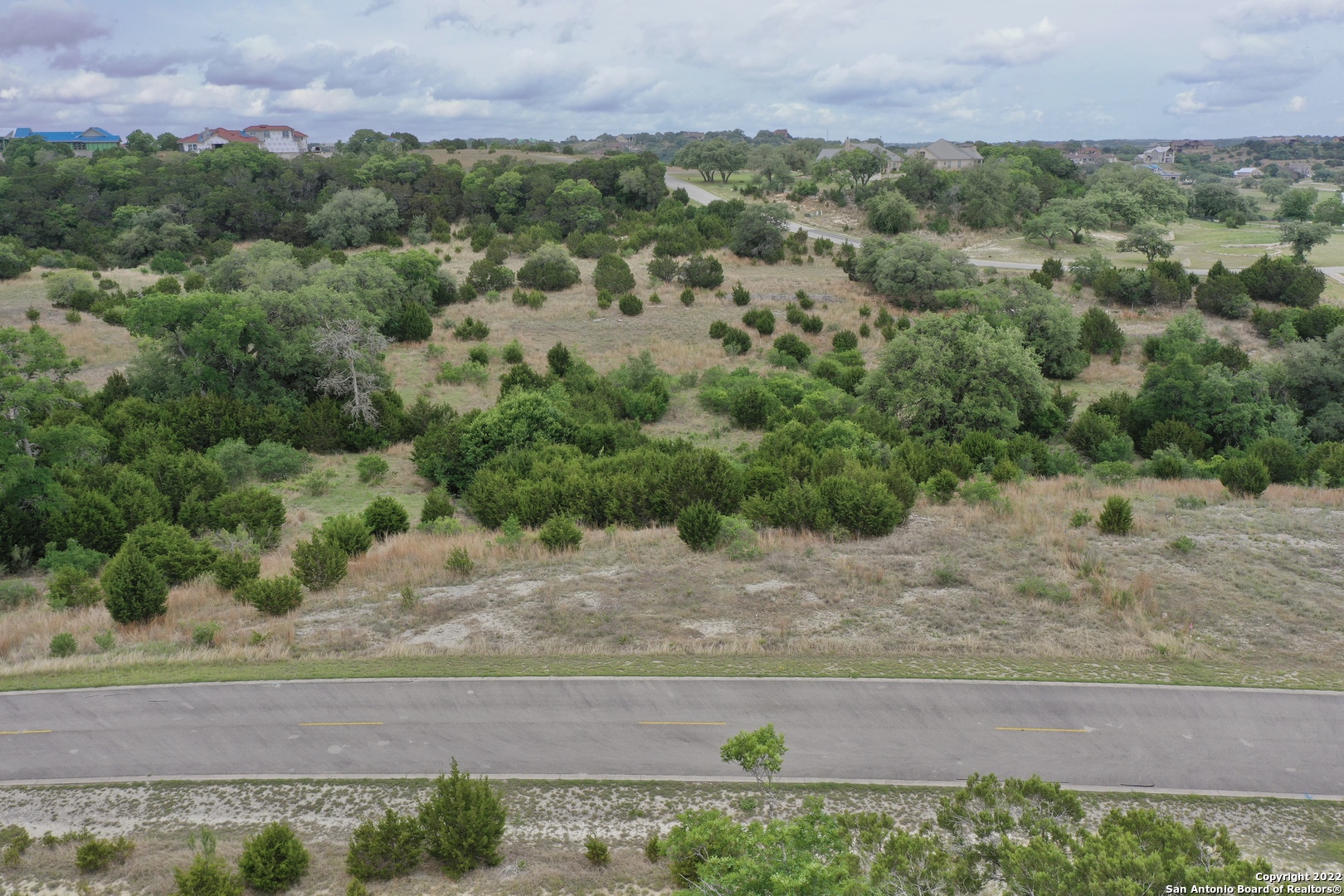 an aerial view of a house with a yard