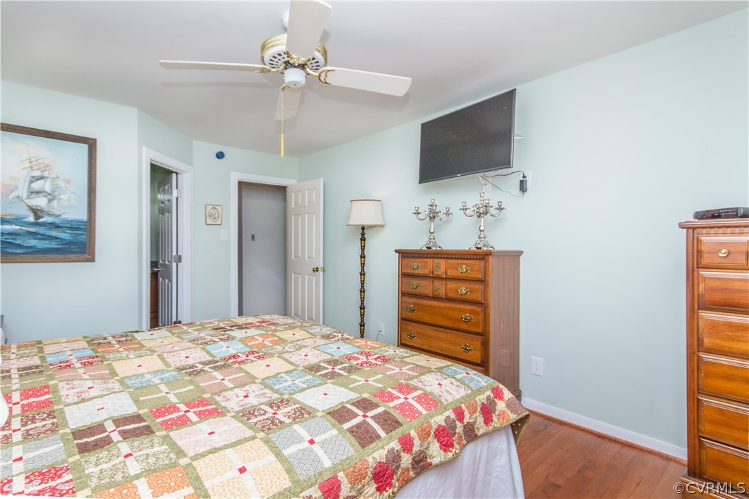 13712 Sandy Oak Road Chester, VA 23831 - Photo 17 of 36 a bedroom with a bed and a flat screen tv