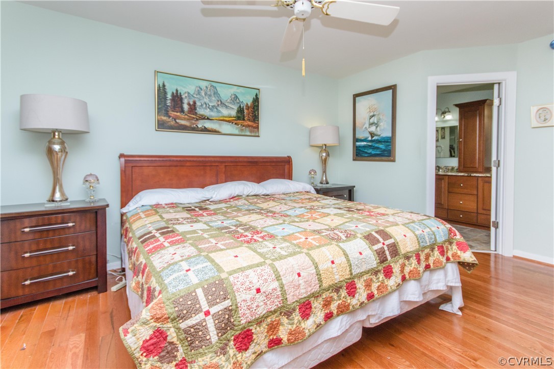 13712 Sandy Oak Road Chester, VA 23831 - Photo 18 of 36 a bedroom with a bed and wooden floor