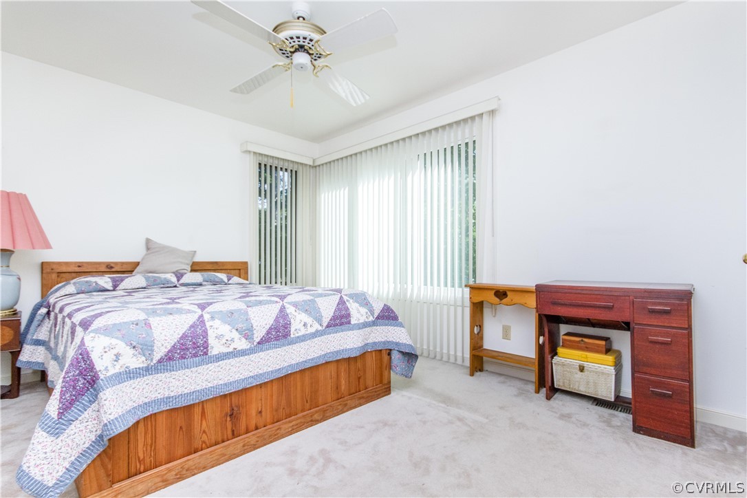 13712 Sandy Oak Road Chester, VA 23831 - Photo 24 of 36 a bedroom with a bed and a chandelier