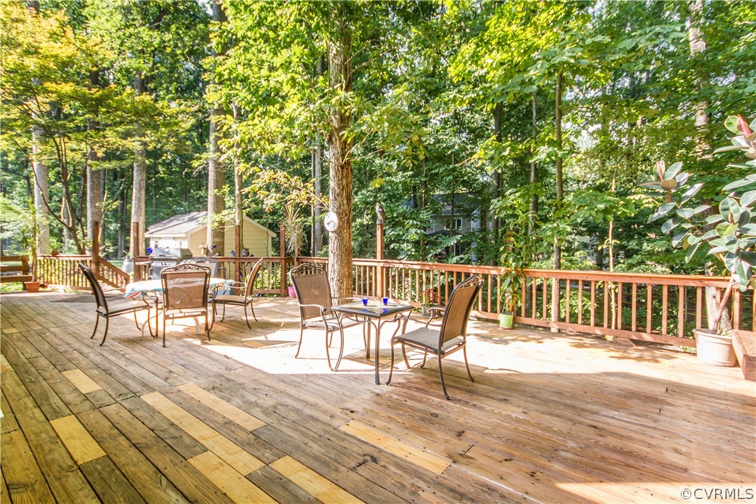 13712 Sandy Oak Road Chester, VA 23831 - Photo 35 of 36 a view of a chairs and table on the wooden deck