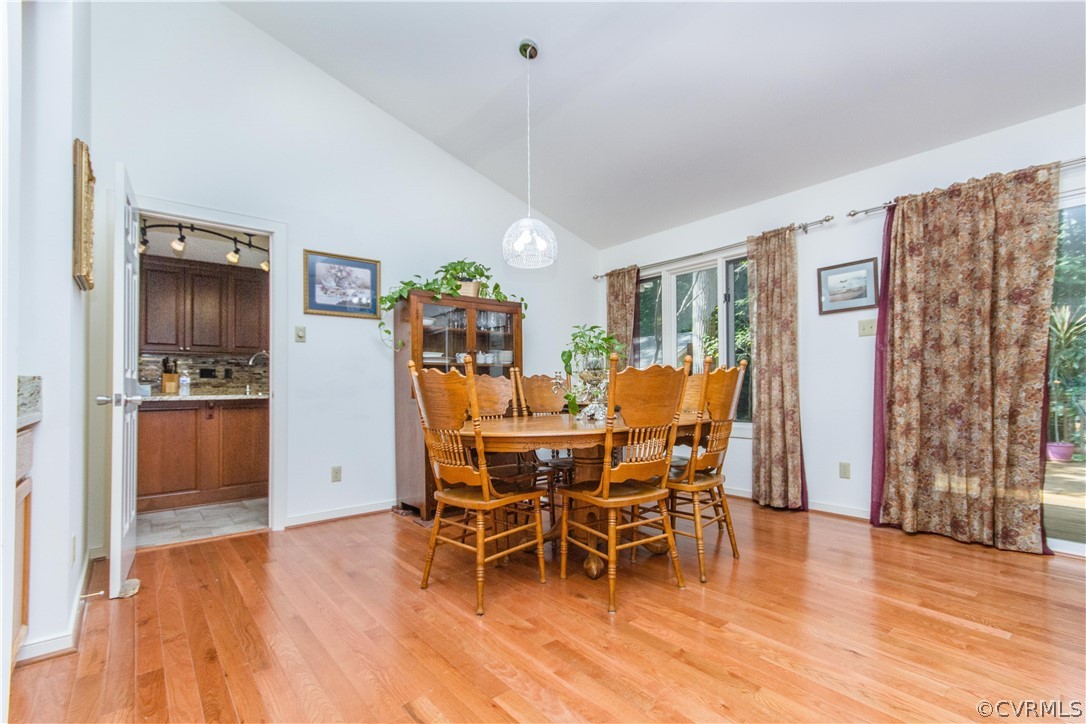 13712 Sandy Oak Road Chester, VA 23831 - Photo 9 of 36 a dining room with furniture a chandelier and wooden floor