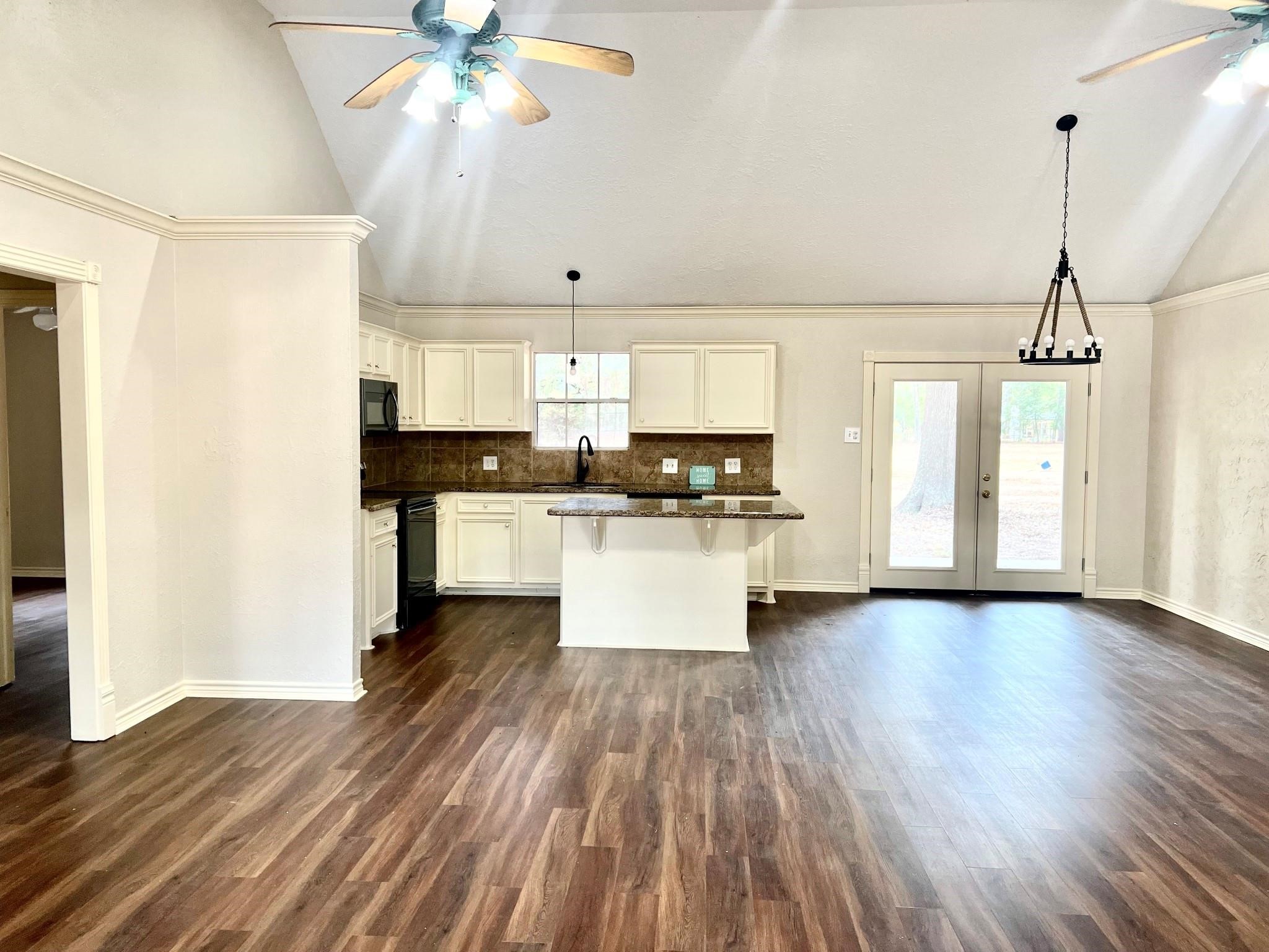 14385 Old Humble Pipeline Road Conroe, TX 77302 - Photo 10 of 10 a kitchen with stainless steel appliances a refrigerator a sink dishwasher a stove and white cabinets with wooden floor