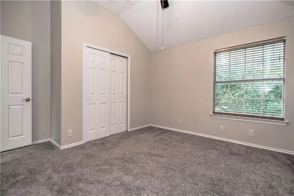 an empty room with windows and closet