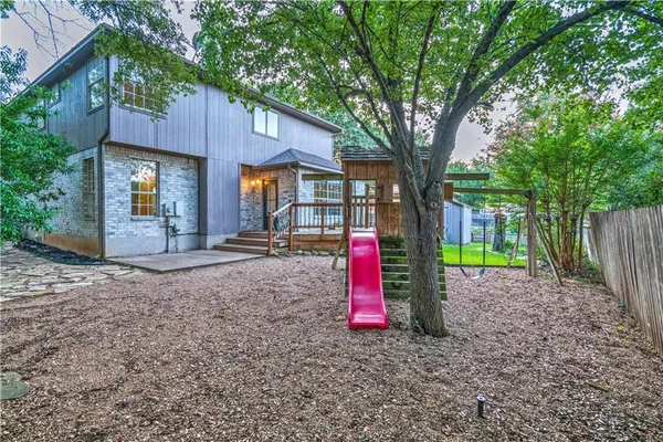 a backyard of a house with barbeque oven
