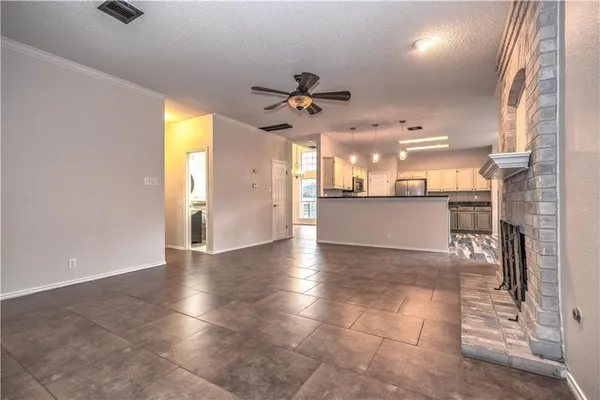 a view of a kitchen with a sink and a chandelier fan