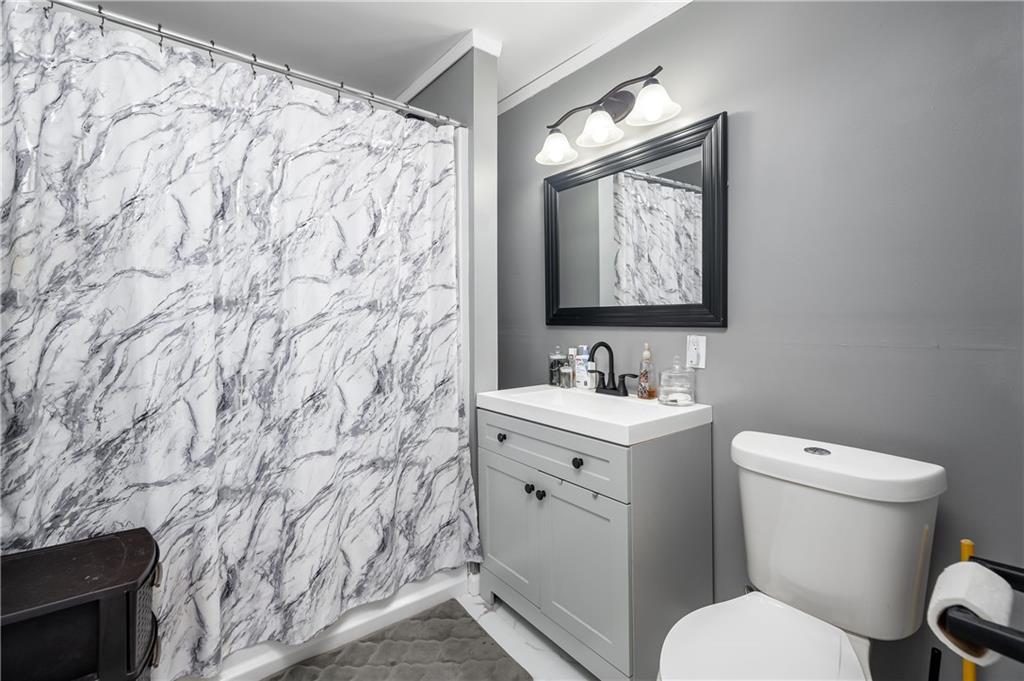 5440 Pittsburgh Road Harrisville, PA 16038 - Photo 12 of 16 a bathroom with a granite countertop toilet sink and mirror