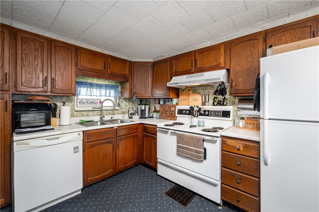 5440 Pittsburgh Road Harrisville, PA 16038 - Photo 2 of 16 a kitchen with a stove a sink and a refrigerator