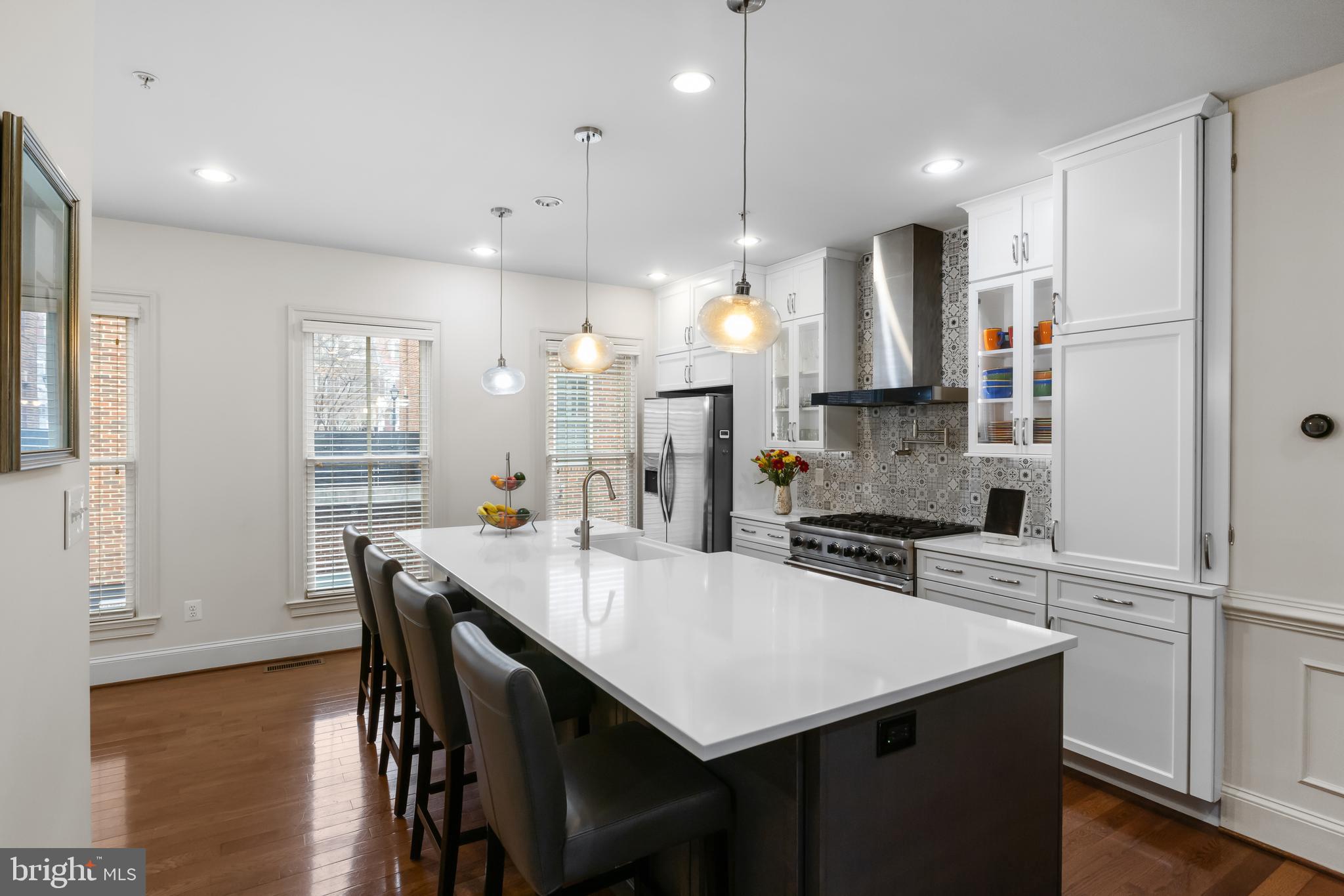 419 Princess Street Alexandria, VA 22314 - Photo 11 of 44 a kitchen with stainless steel appliances a table chairs refrigerator and microwave