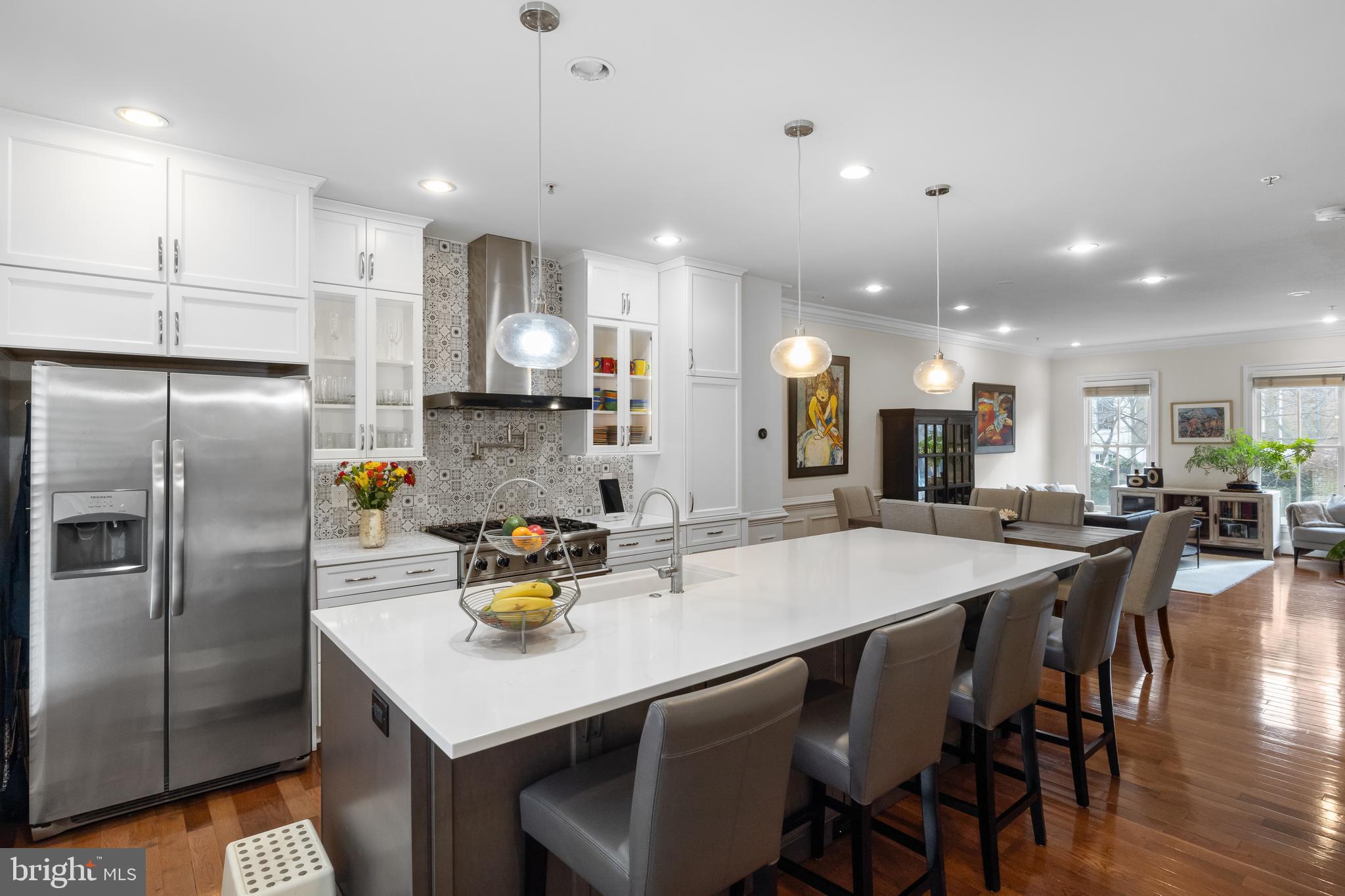 419 Princess Street Alexandria, VA 22314 - Photo 12 of 44 a kitchen with stainless steel appliances granite countertop a dining table chairs refrigerator and microwave