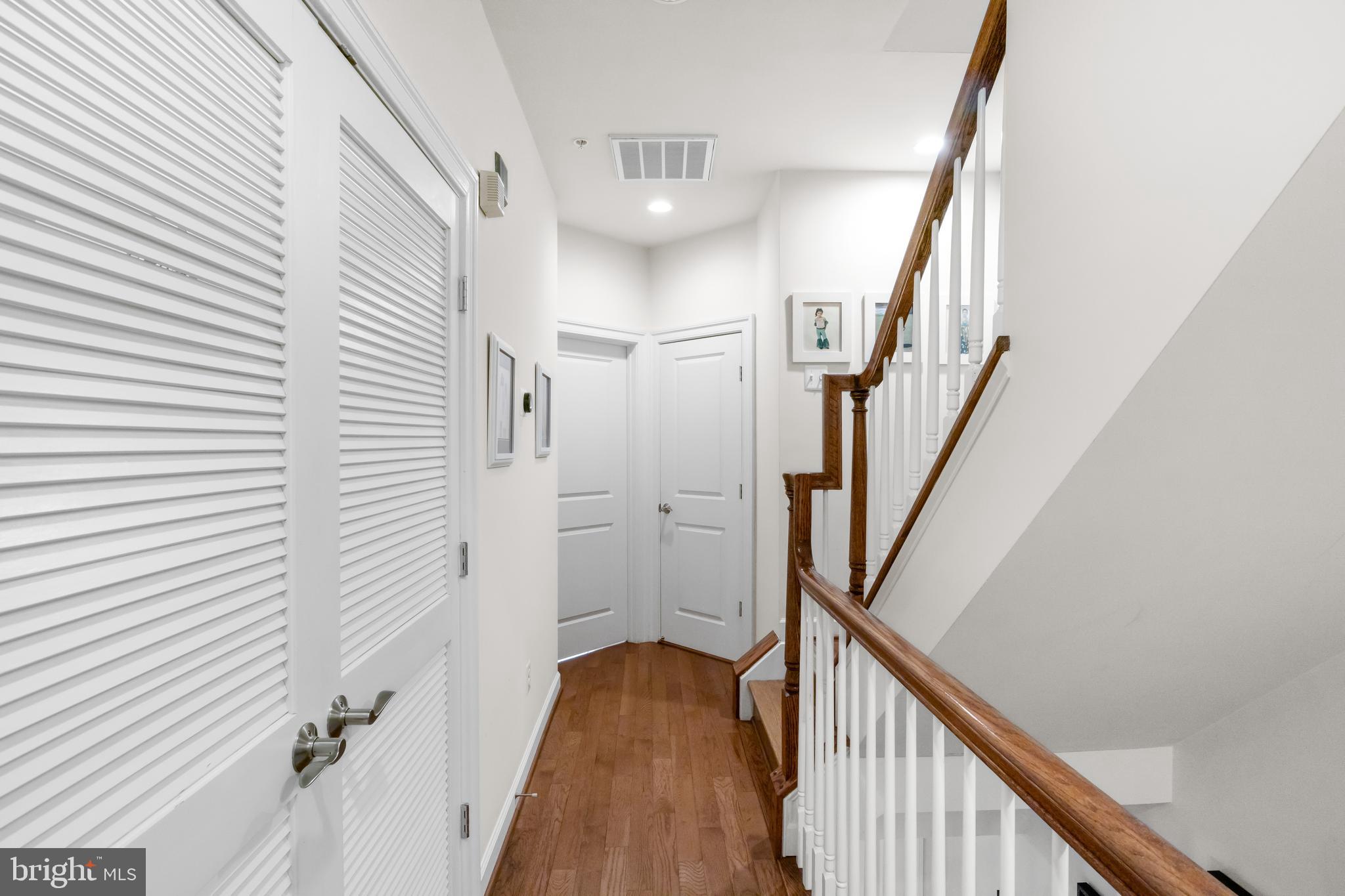 419 Princess Street Alexandria, VA 22314 - Photo 25 of 44 a view of a hallway with wooden floor and staircase