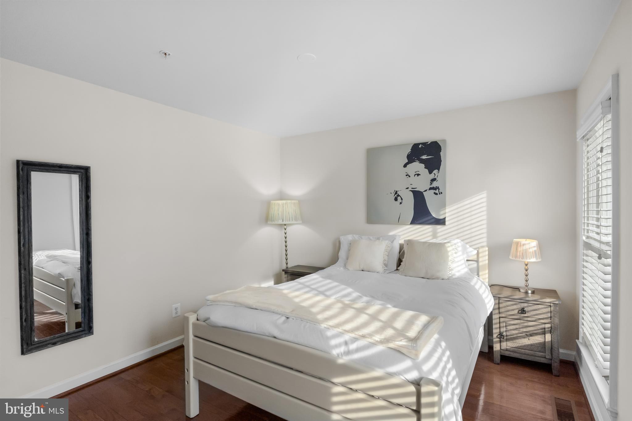 419 Princess Street Alexandria, VA 22314 - Photo 32 of 44 a bedroom with a bed and a painting on the wall